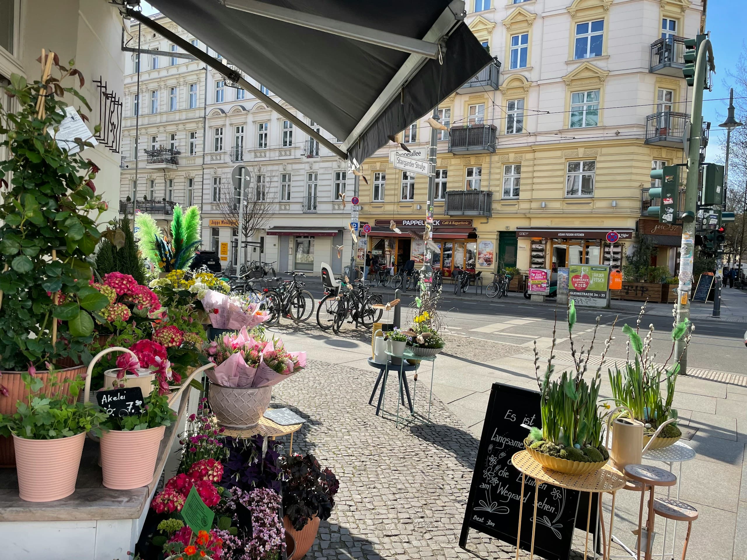 A pavement flower shop in front of Altbau facades in Prenzlauer Berg